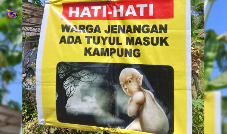 Banner peringatan agar masyarakat hati-hati cukup menarik perhatian warga dan netizen. (Foto/Joko)